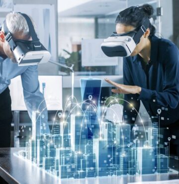 Frau und Mann mit VR-Brillen über virtuellem 3D-Modell einer Stadt